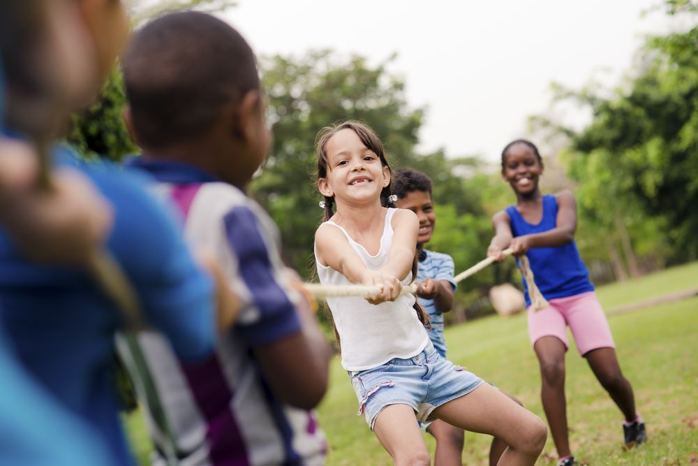 kids playing tug of war at camp
